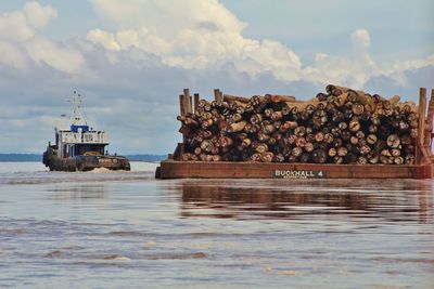 Stack of ship by sea against sky