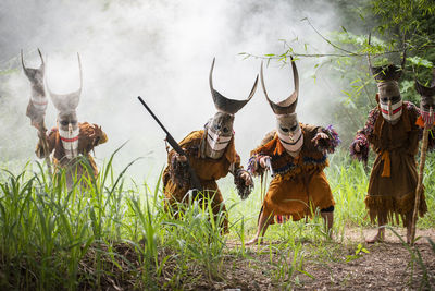 Group of people wearing costume standing on field