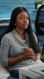 Portrait of a young woman sitting in car