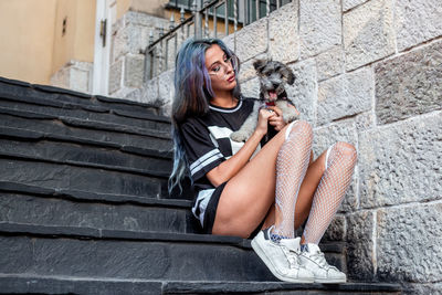 Portrait of young woman sitting on steps