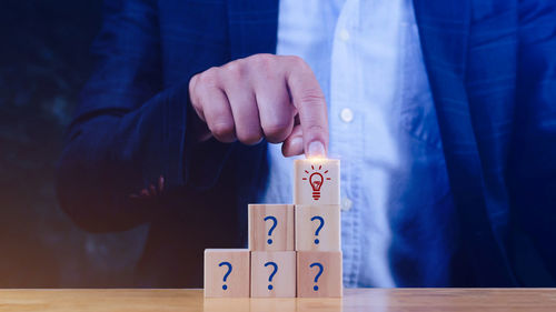 Midsection of businessman gesturing on table