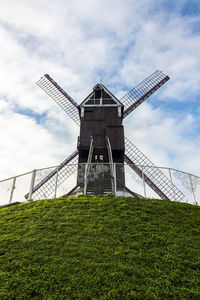 Low angle view of traditional windmill against sky