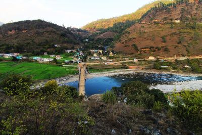 Scenic view of lake by mountains against sky