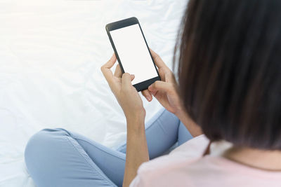 Midsection of woman using mobile phone