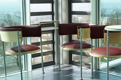 Empty chairs and tables in room