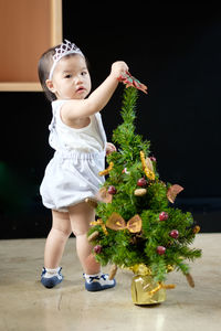 Cute girl holding christmas tree