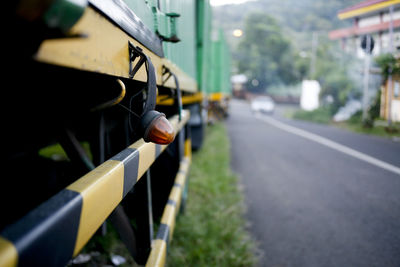 Close-up of yellow car on street