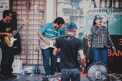 People playing guitar in city