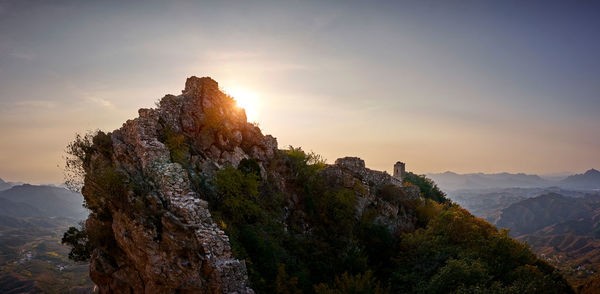 Rock formations on landscape against sky