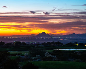 Scenic view of field against romantic sky at sunset