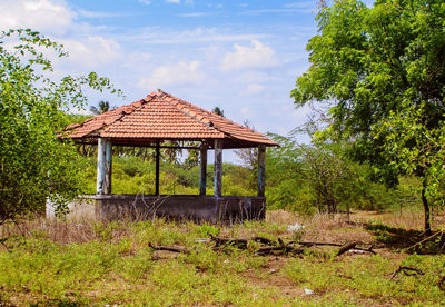 Built structure on field against sky