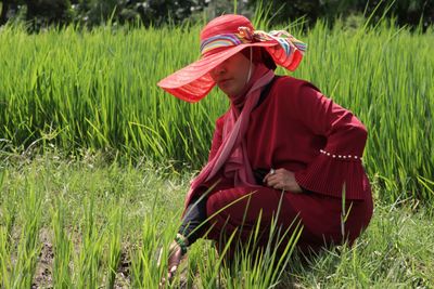 Rear view of woman standing on field