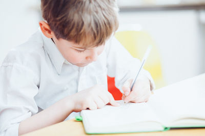 Boy writing at table