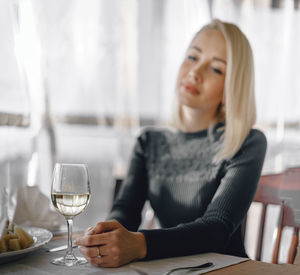 Portrait of a young woman sitting on table