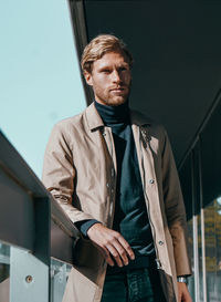 Mid adult man standing against wall