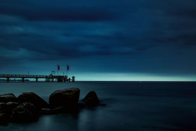 Scenic view of sea against sky at dusk