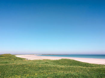 Scenic view of sea against clear blue sky