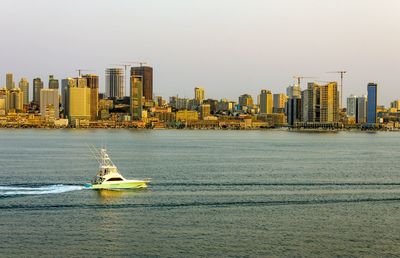 Boat sailing on sea against clear sky