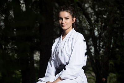 Portrait of young woman standing outdoors