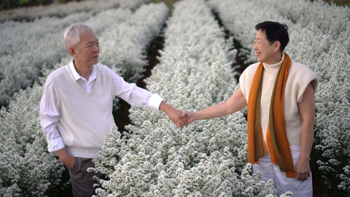 Side view of a couple standing outdoors