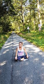 Portrait of man sitting on road