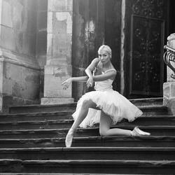 Portrait of young woman sitting on staircase