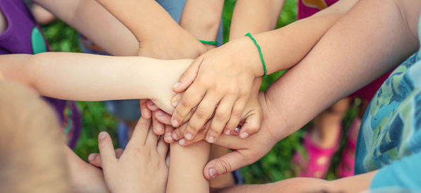 High angle view of kids with stacked hands