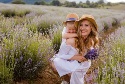 Beautiful young woman with yellow flowers on field