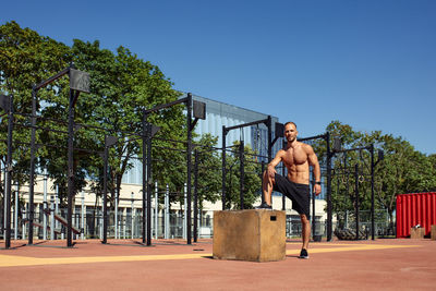 Full length of man standing against clear blue sky