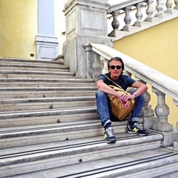 Portrait of young man sitting on steps