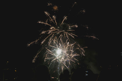 Low angle view of firework display at night