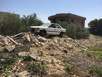 Car parked by building against clear sky
