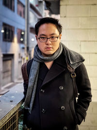 Portrait of young man standing in snow