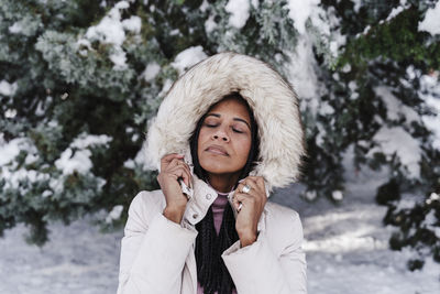Portrait of woman standing in snow