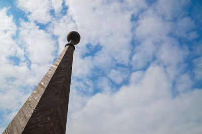 Low angle view of tower against cloudy sky