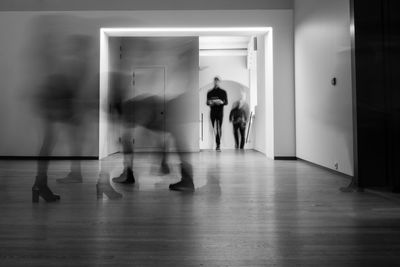 People walking in corridor of building