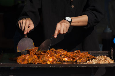 Close-up of chef cooking meat