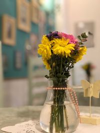 Close-up of yellow flower vase on table