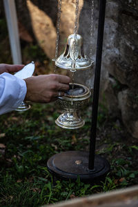 Cropped hand of man performing worship in temple