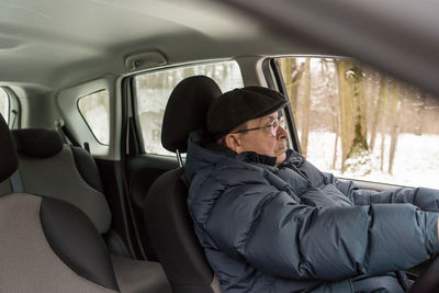 Rear view of woman sitting in car