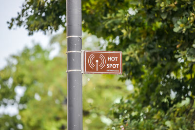 Low angle view of road sign against trees