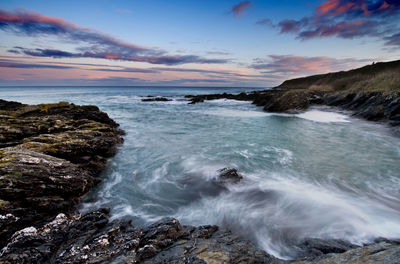 View of water splashing on rocks at sea