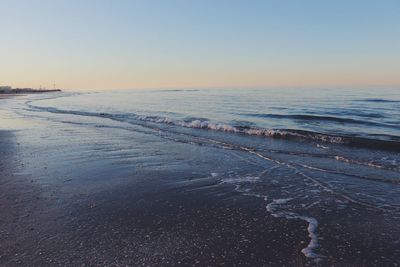 Scenic view of sea against clear sky during sunset