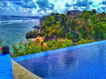 High angle view of swimming pool by sea against sky