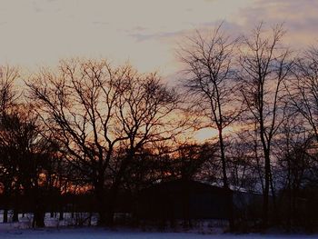 Snow covered field at sunset