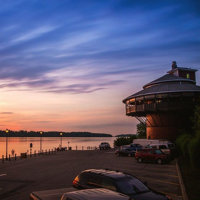 transportation, sunset, mode of transport, sky, car, built structure, water, land vehicle, building exterior, architecture, cloud - sky, sea, nautical vessel, city, outdoors, moored, cloud, nature, boat, road