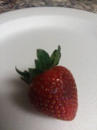 Close-up of strawberry over white background