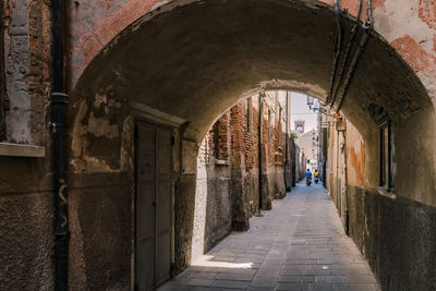 Narrow corridor along old building