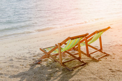 High angle view of empty chair on beach