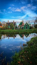 Scenic view of lake by building against sky